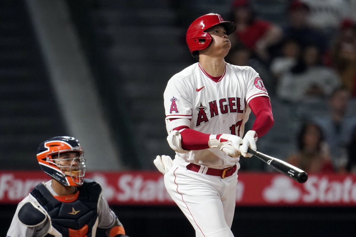 Angels star Shohei Ohtani hits a home run against the Houston Astros on Sept. 21, 2021, at Angel Stadium.