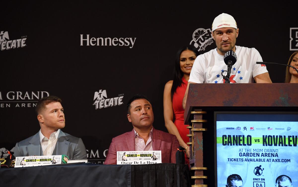 WBO light-heavyweight champion Sergey Kovalev speaks in front of his opponent Canelo Alvarez, far left, during a news conference at the KA Theatre at MGM Grand Hotel & Casino in Las Vegas.