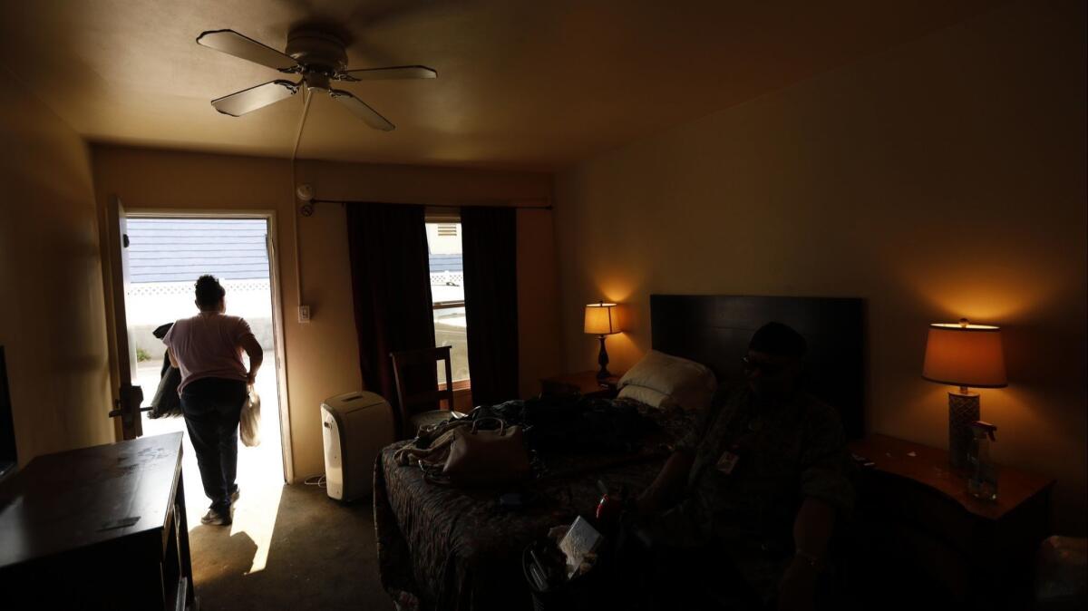 Carla McCue, 62, packs up after she and her husband Lawrence, 75, finished a 45-day stay at a motel in West Hollywood on July 27, 2018. They plan to sleep in their car, parked for the night on the VA campus in Los Angeles.