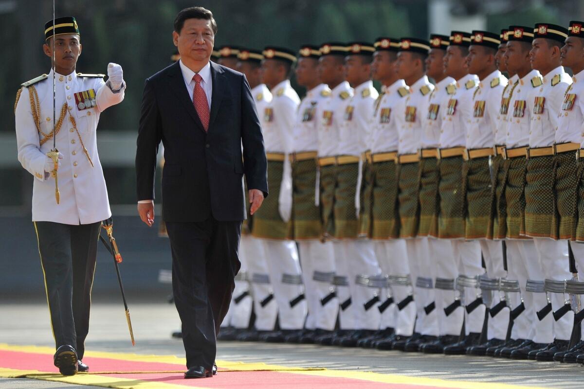 Chinese President Xi Jinping inspects the Royal Malay Regiment Guard of Honor during a welcoming ceremony at the parliament in Kuala Lumpur.