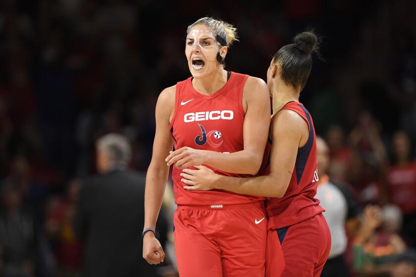 Washington Mystics forward Elena Delle Donne, left, reacts with guard Natasha Cloud, right, after she made a basket during the second half against the Las Vegas Aces in Game 1 of a WNBA playoff basketball series Tuesday, Sept. 17, 2019, in Washington. The Mystics won 97-95. (AP Photo/Nick Wass)