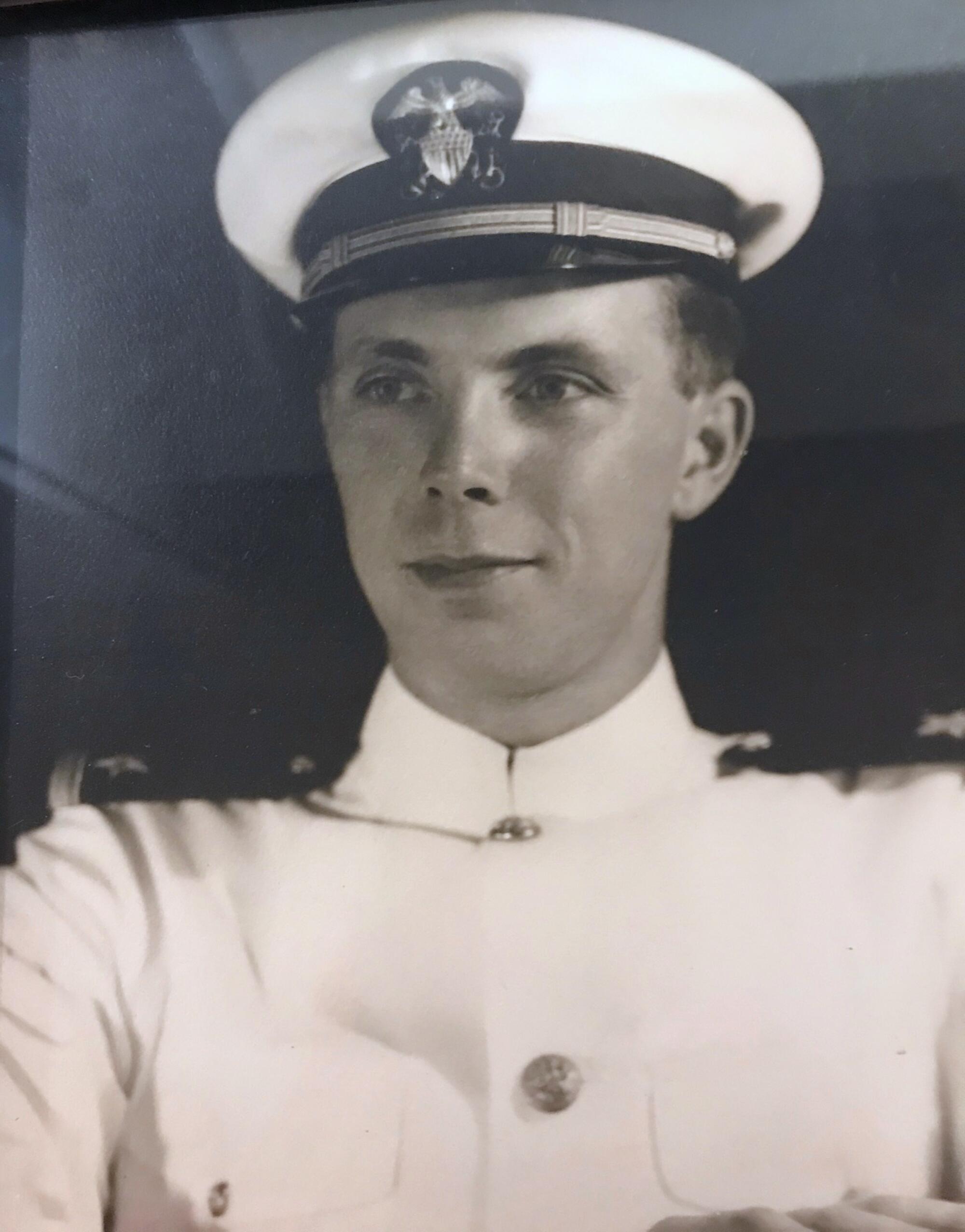 Robert Adrian in a white Navy uniform.