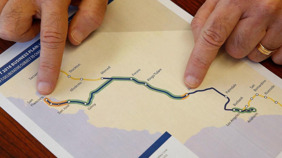 Dan Richard, chairman of the board that oversees the California High-Speed Rail Authority, displays a map showing the planned route for the bullet train.
