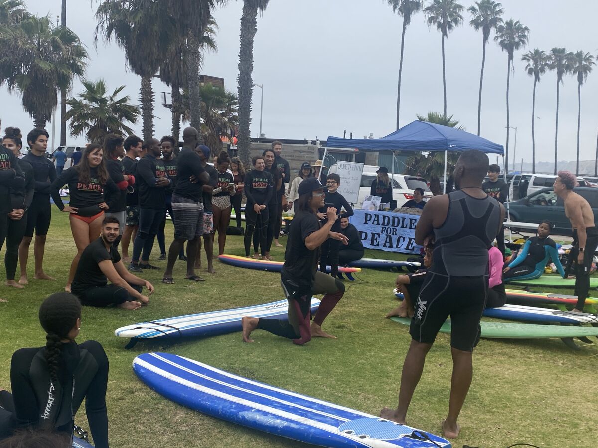 Volunteer instructors gave lessons to about 40 surfing newbies during a celebration of International Surf Day and Juneteenth.