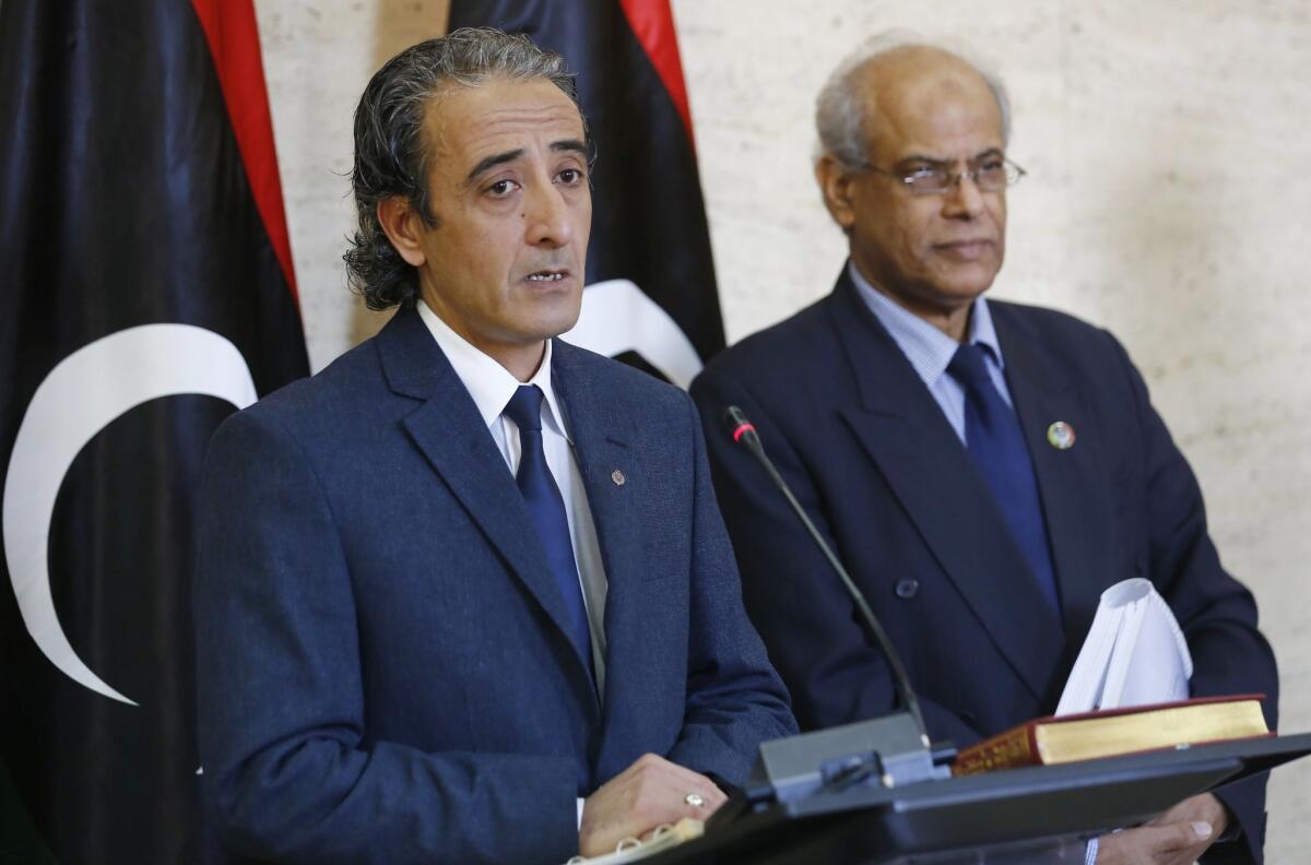 Libyan Culture Minister Habib Mohammed Amin speaks as Justice Minister Salah Mirghani, right, listens during a news conference on developments surrounding an attempt by a rebel militia to load crude oil into a North Korean-flagged tanker, sell it and keep the profits.