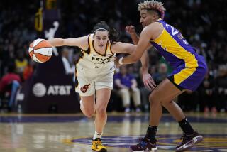 Los Angeles Sparks guard Layshia Clarendon, right, defends against Indiana Fever guard Caitlin Clark (22) during the first half of a WNBA basketball game in Los Angeles, Friday, May 24, 2024. (AP Photo/Ashley Landis)