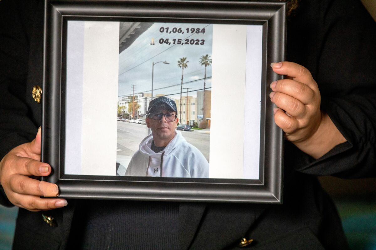 A central frame of a framed portrait of a man wearing glasses, a hat, and a hooded sweatshirt.