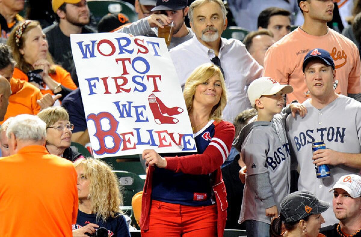 A Red Sox fan holds up a sign during the game against the Orioles on Friday at Camden Yard in Baltimore.