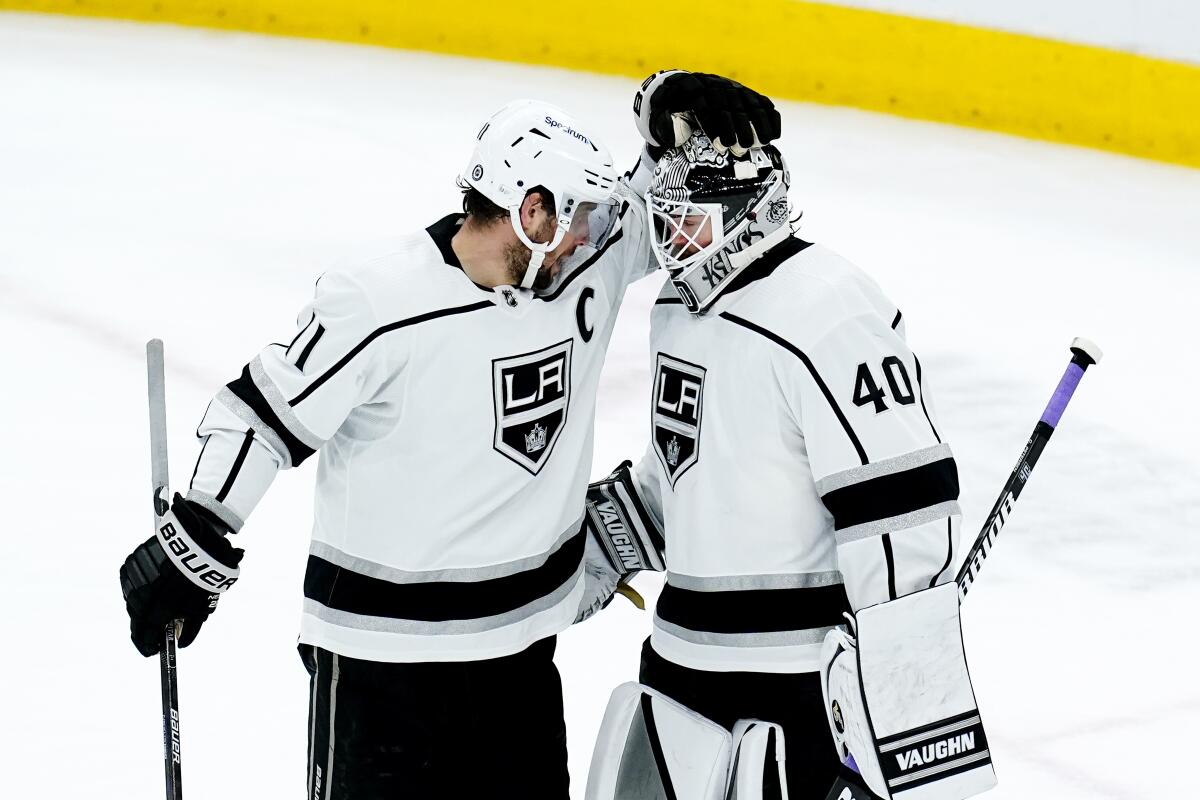 Kings center Anze Kopitar congratulates goalie Cal Petersen after L.A. won for the second time in as many nights.