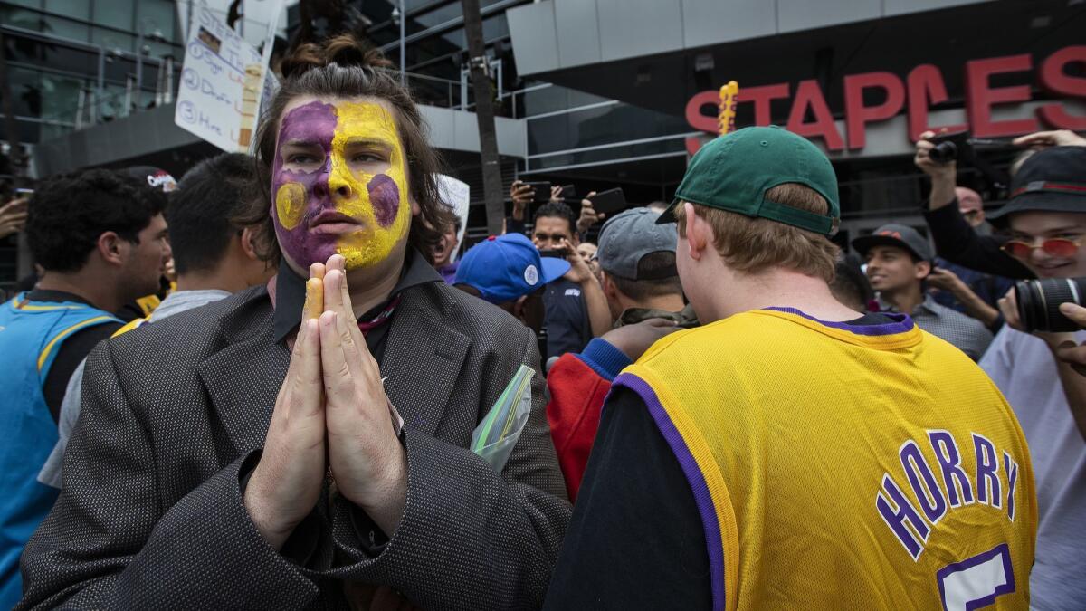 Diano Merchel, wearing the Lakers' colors on his face, protests with other fans outside Staples Center on May 10.