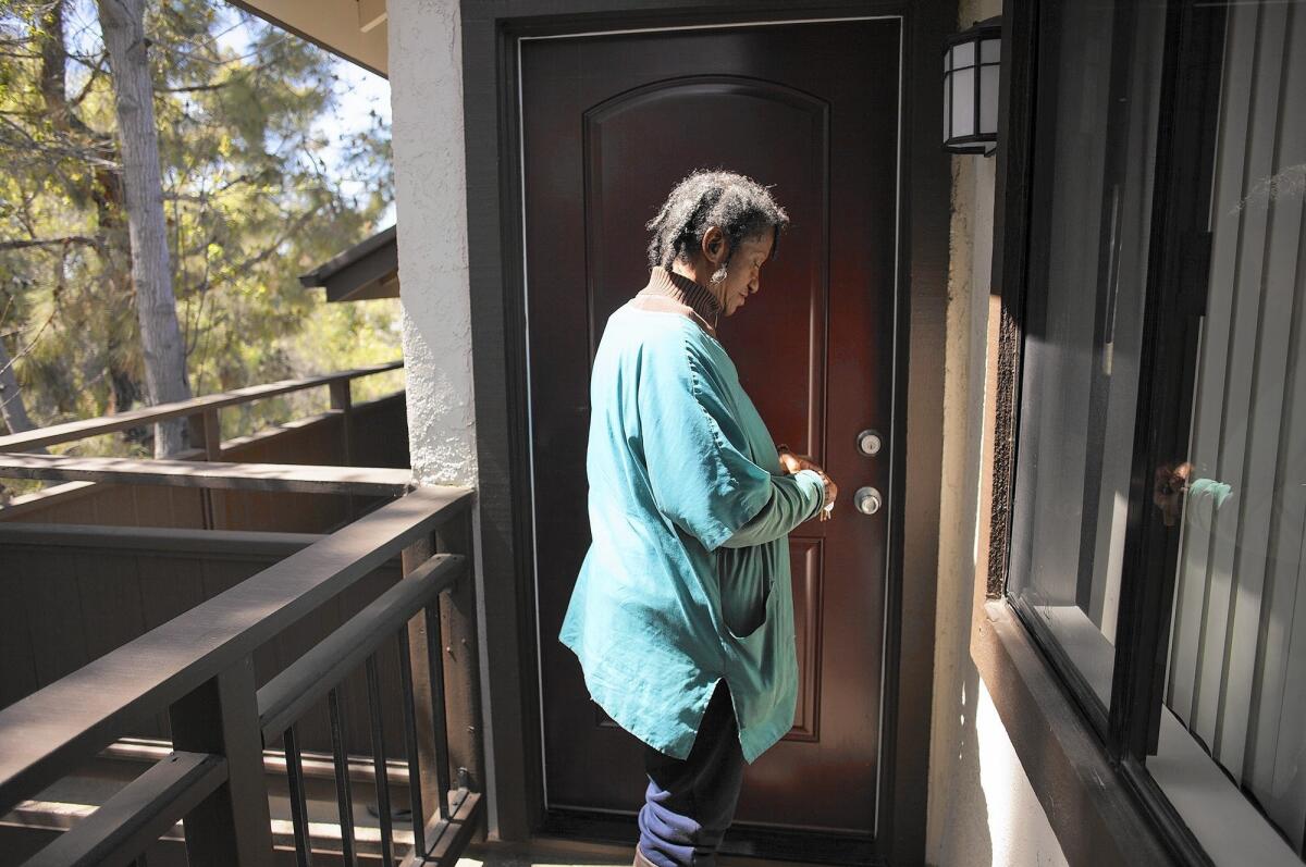 Toni Horn stands at the door of her one-bedroom, one-bath apartment in Lake Forest. Part of her Social Security check will cover the $260 monthly rent for the apartment, which normally would cost around $1,800.