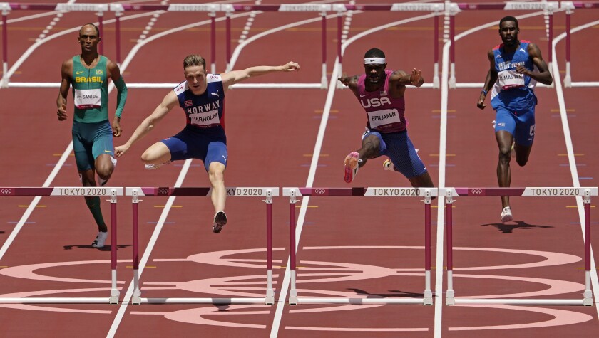 Norway's Karsten Warholm clears the final hurdle ahead of Rai Benjamin of the U.S. and two other opponents