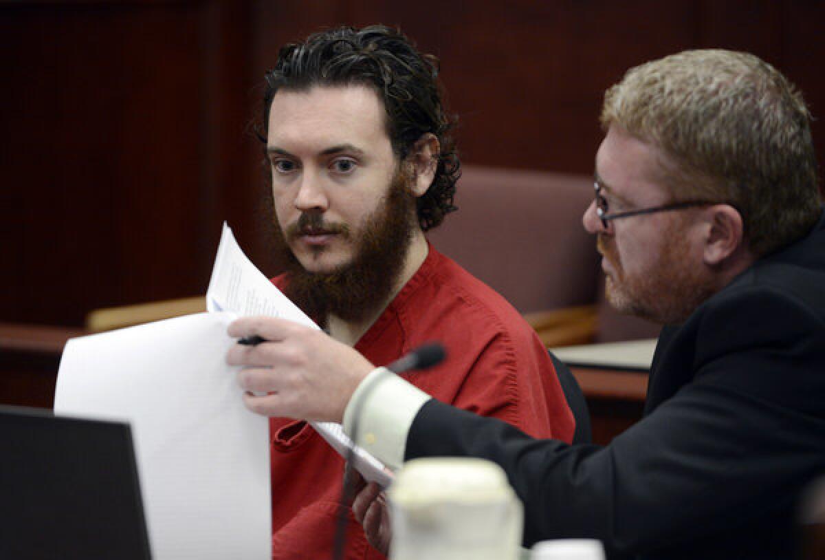 Defense Attorney Daniel King, right, and Aurora theater shooting suspect James Holmes review documents during a June court hearing in Centennial, Colo.