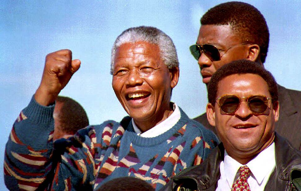 Nelson Mandela and regional African National Congress leader Allan Boesak, right, greet the crowd at a campaign rally on April 17, 1994, 10 days before South Africa's first all-race national elections.