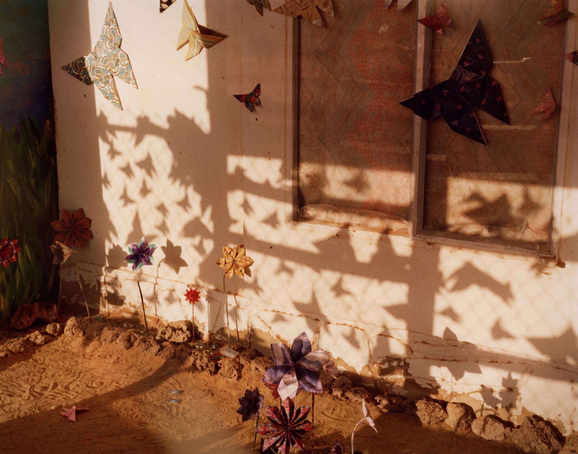 Butterfly shadows and cutouts adorn the front of a building.
