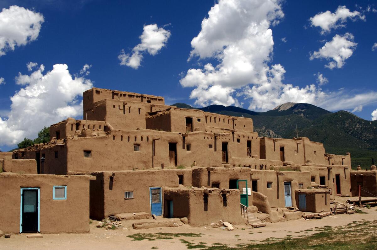Adobe buildings in Taos Pueblo, inhabited by Tiwa Indians of the Pueblo tribe, in New Mexico is a UNESCO World Heritage Site.