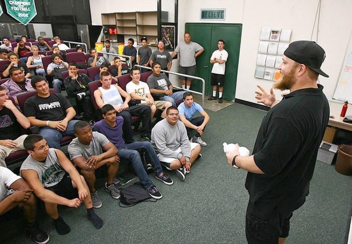 Sam Baker, a three-time All-American tackle at USC and a current starting left tackle for the Atlanta Falcons, talks to Costa Mesa High football players on Wednesday.