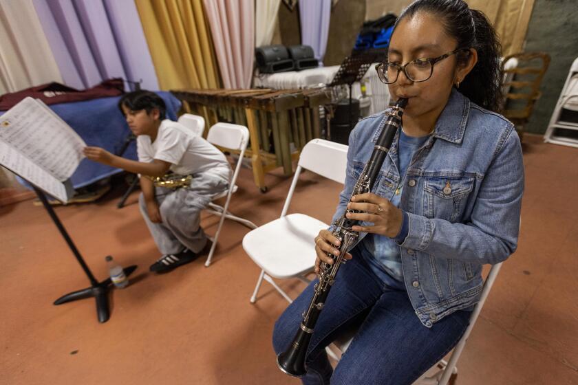 Daisy Herrera Beltran plays clarinet at Maqueos Music Academy, where students learn Oaxacan music, in Los Angeles on Feb. 2, 2024.