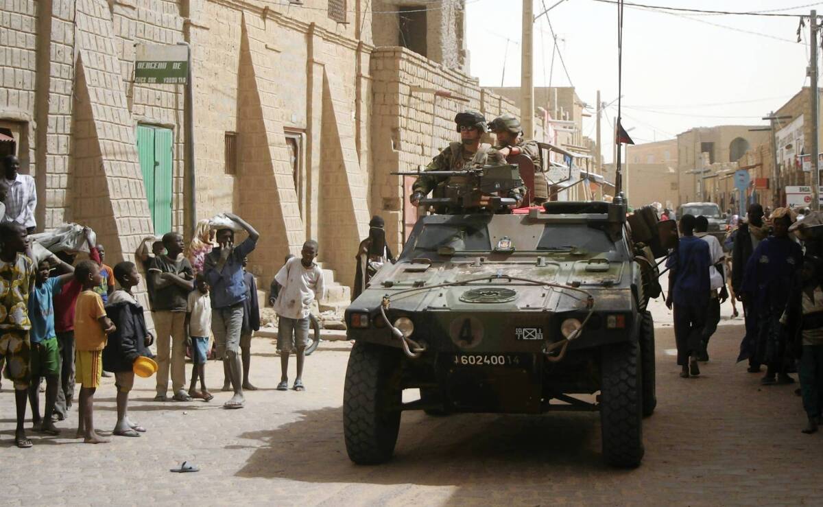 French troops make their way down a street in Timbuktu, Mali.