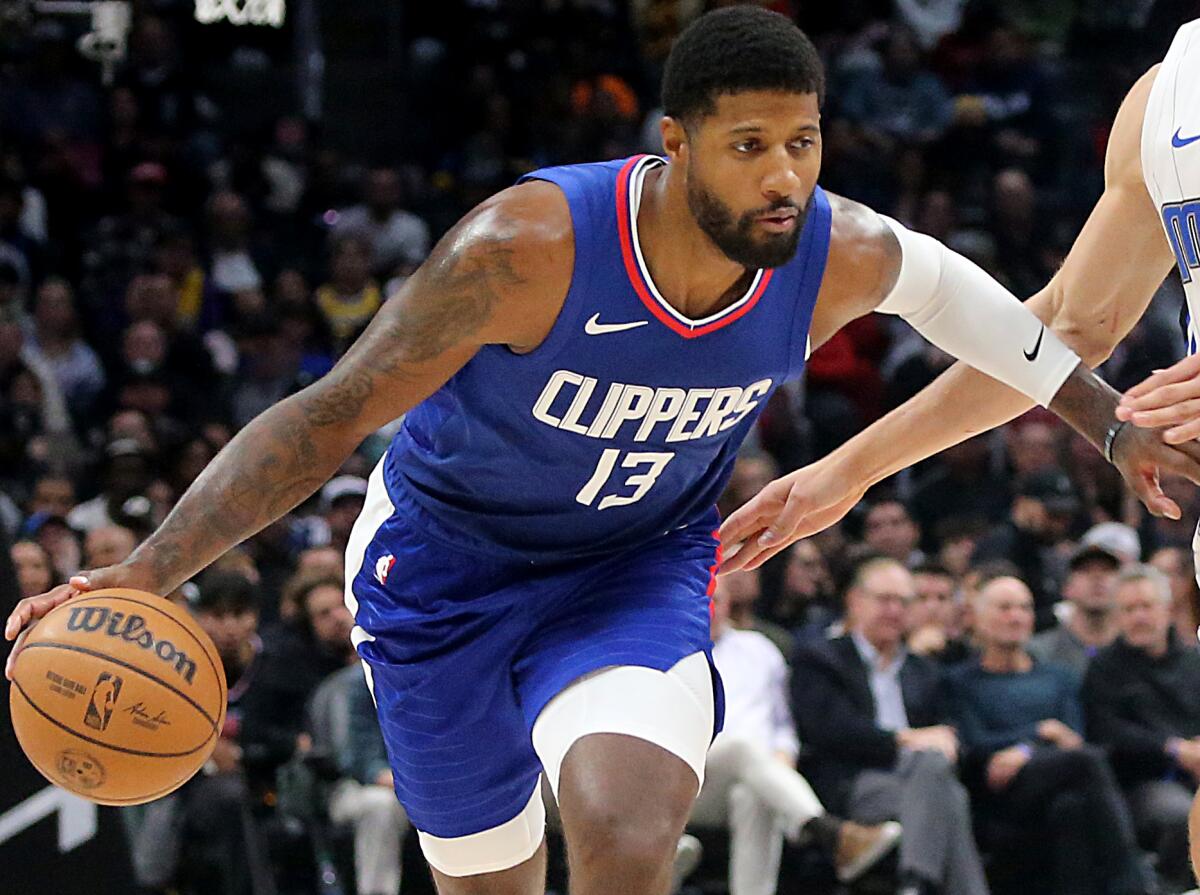 Clippers forward Paul George controls the ball during a game against Orlando in October.