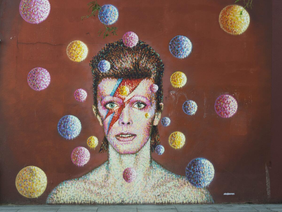 A mural in South London is inspired by David Bowie's "Aladdin Sane" album cover. An exhibition about Bowie's life opens in Chicago on Tuesday.