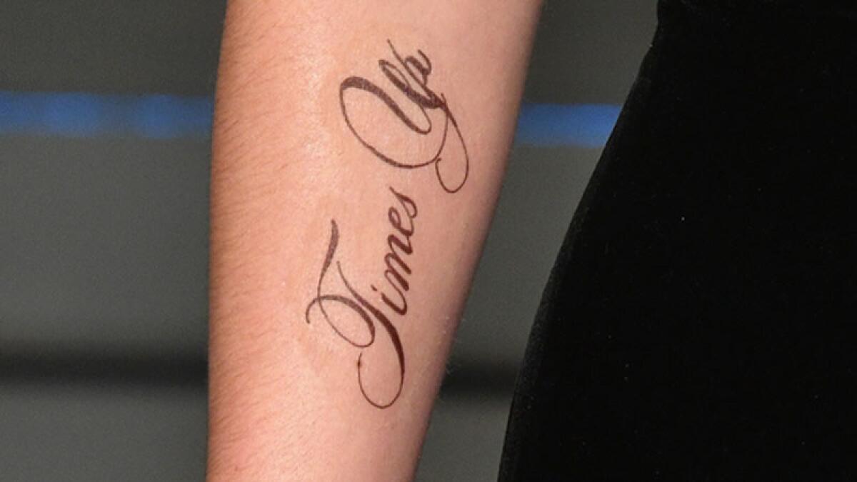 A close-up of Emma Watson's "Times Up" tattoo.