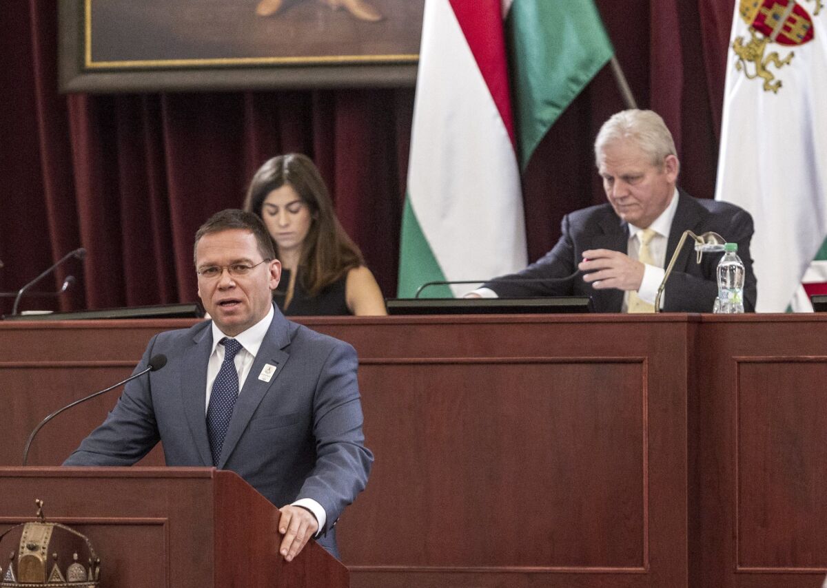 Balazs Furjes, head of Budapest's bid to host the 2024 Summer Olympic Games, addresses the city's General Assembly on Feb. 22. Mayor Istvan Tarlos and Vice Mayor Alexandra Szalay-Bobrovniczky are in the background.