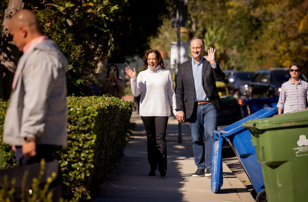 A photo of Vice President Kamala Harris and Second Gentleman Douglas Emhoff walking through their neighborhood in L.A.