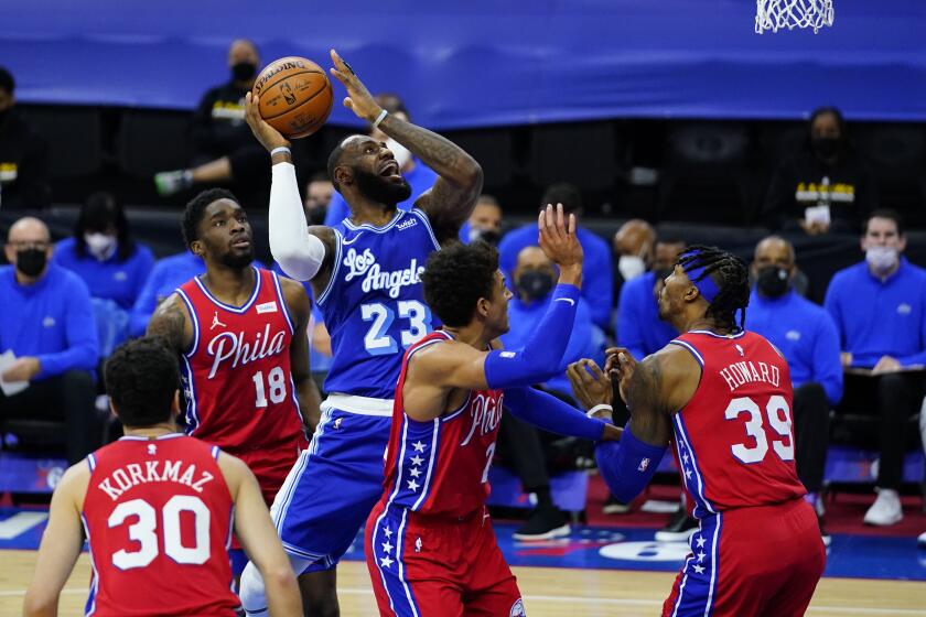 Los Angeles Lakers' LeBron James (23) goes up for a shot against Philadelphia 76ers' Dwight Howard (39), Matisse Thybulle (22), Shake Milton (18) and Furkan Korkmaz (30) during the first half of an NBA basketball game, Wednesday, Jan. 27, 2021, in Philadelphia. (AP Photo/Matt Slocum)