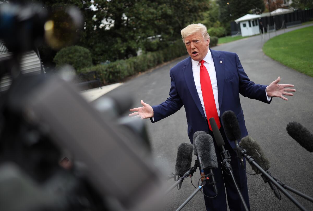 President Trump answers questions while departing the White House on Oct. 3, 2019.