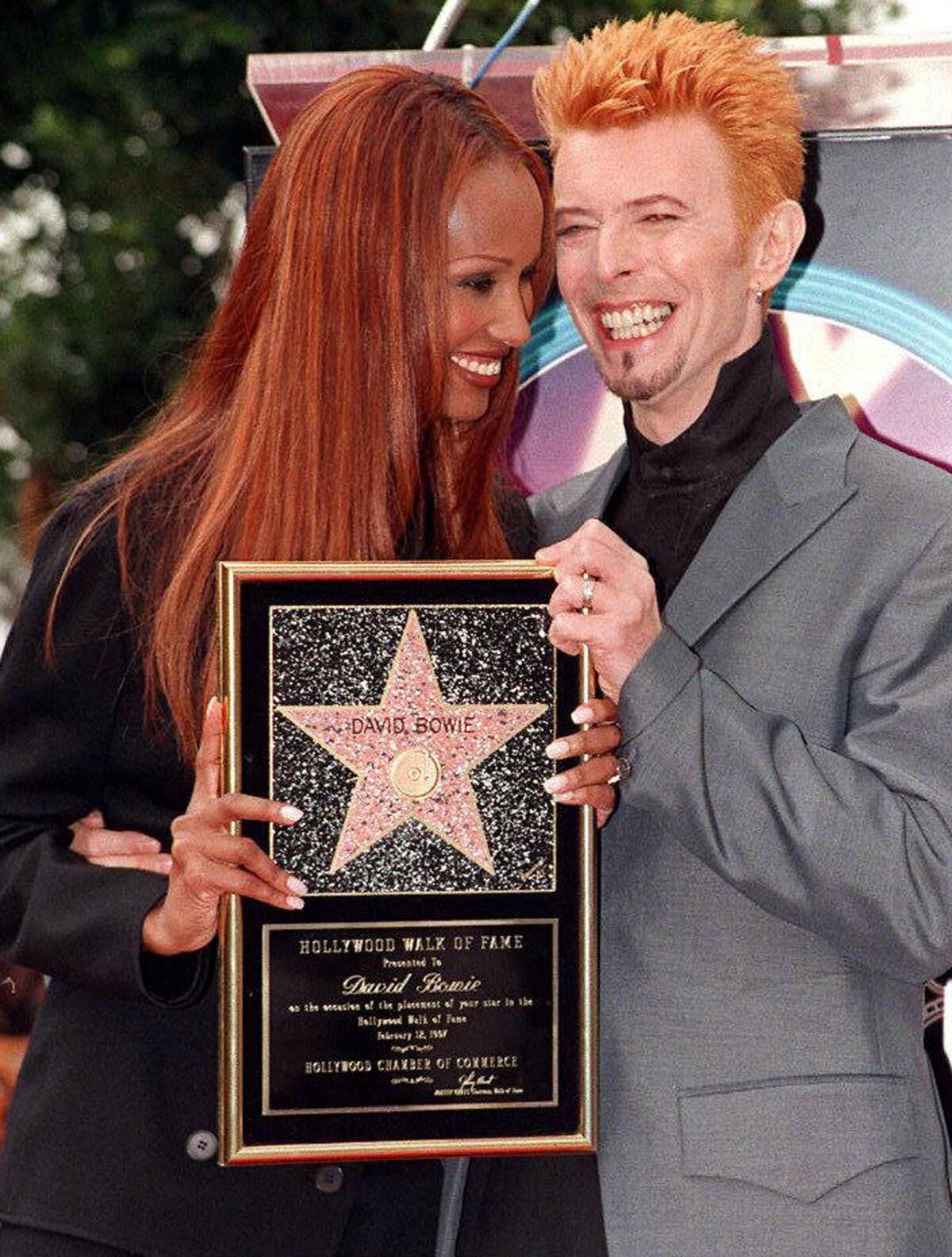David Bowie and his wife, Iman, smile after Bowie received a star on the Walk of Fame in Hollywood on Feb. 12, 1997.