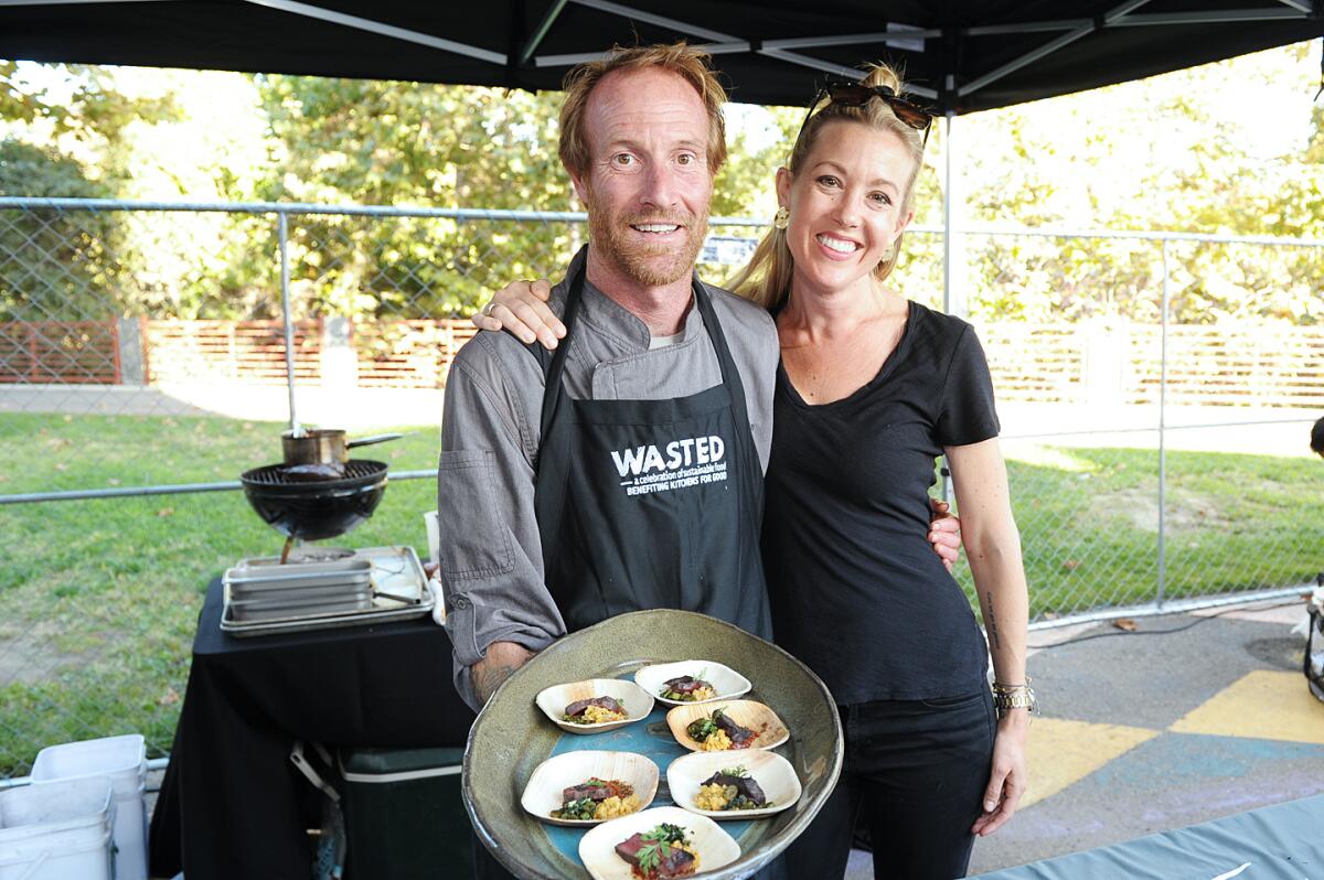 avin and Jessica Waite of Wrench & Rodent Seabasstropub in Oceanside with a plateful of grilled beef heart cuts with avocado pit mole at Wasted: A Celebration of Sustainable Food at Kitchens for Good in San Diego. 