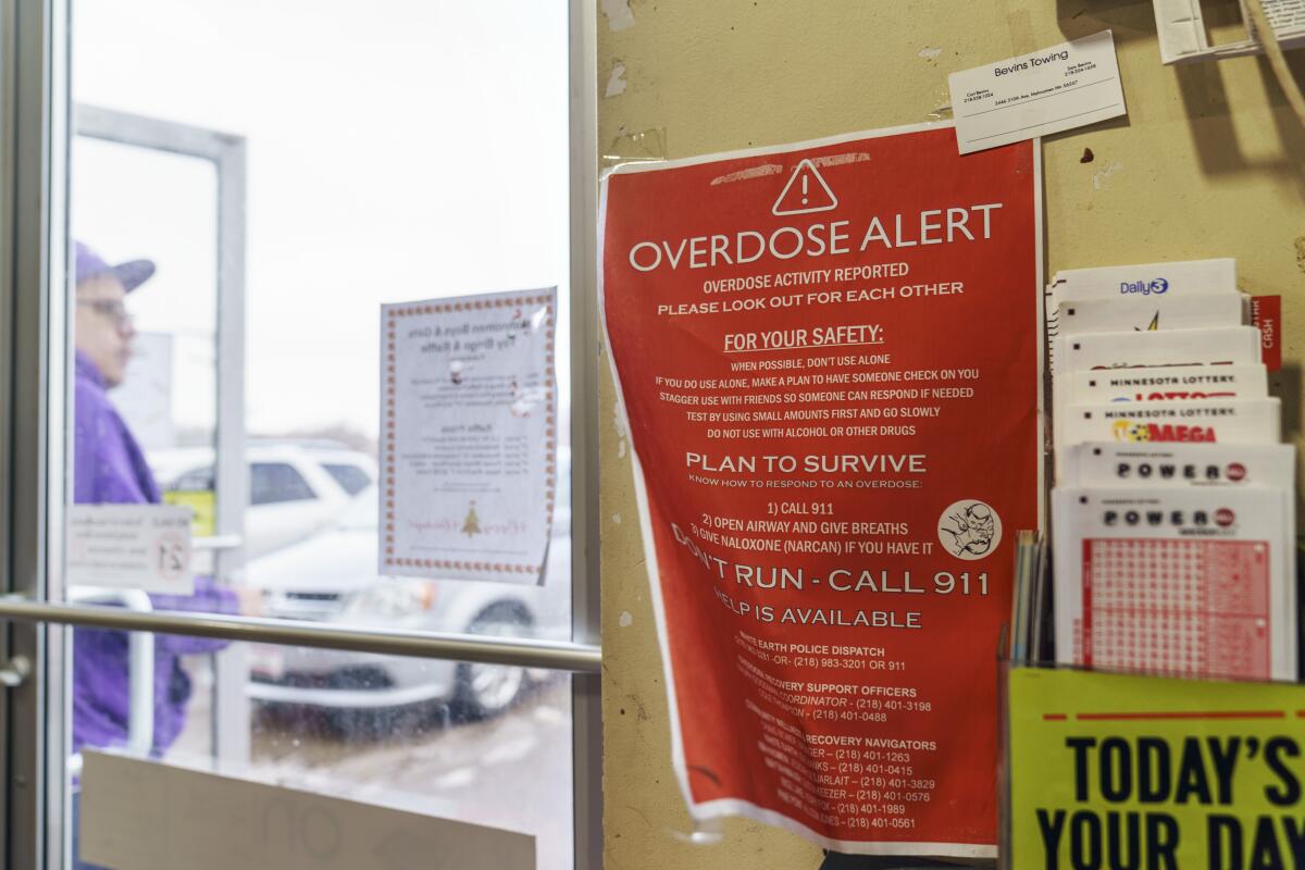 A sign calling attention to drug overdoses is posted to the door of a gas station on the White Earth reservation.