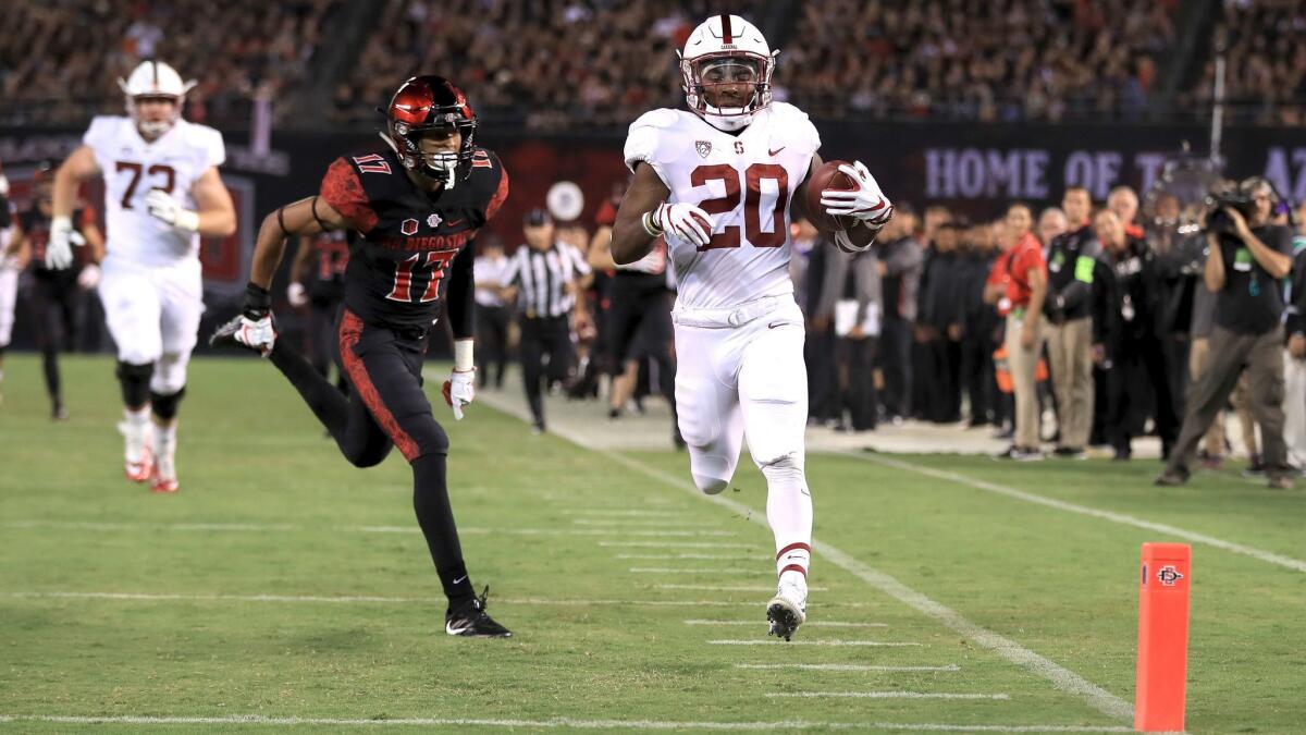 Stanford's Bryce Love runs past San Diego State's Ron Smith on Sept. 16 at Qualcomm Stadium.