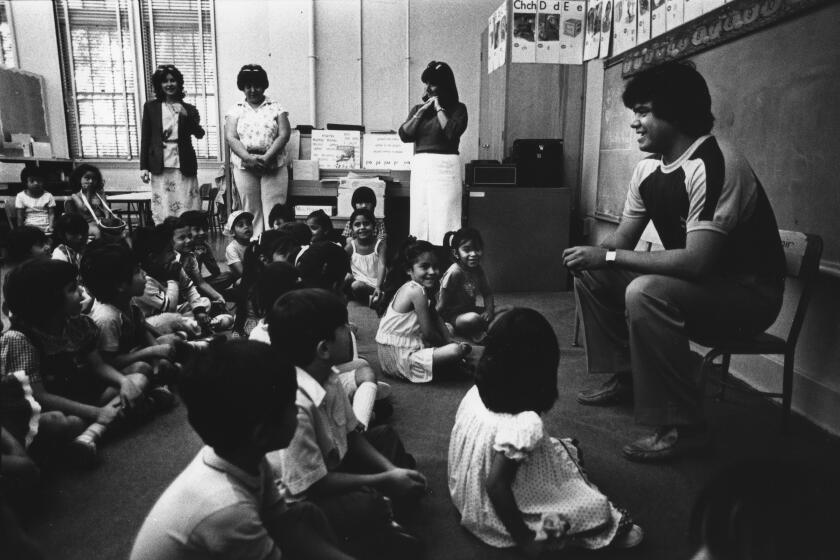Images from the Los Angeles Times 1984 Pulitzer Prize Award for Public Service, "Latinos", a 27-part series on Southern California's latino community and culture in the early 1980s. Los Angeles, CA. Los Angeles Dodgers Pitcher Fernando Valenzuela talking to Kindergarten kids at Aldama Elementary School in Highland Park. (Los Angeles Times / Jose Galvez)