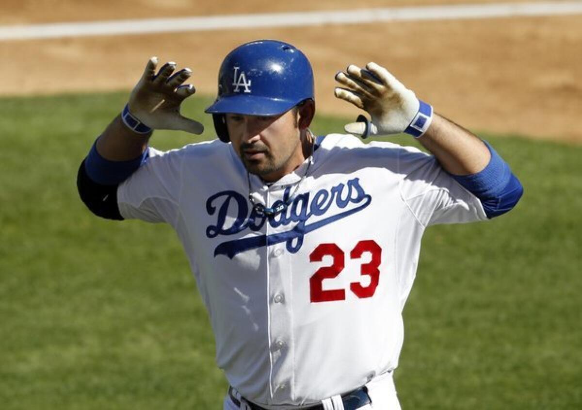 Dodgers first baseman Adrian Gonzalez gives the "Mickey Mouse ears" look after hitting a solo home run in the third inning of Game 5 of the National League Championship Series against the Cardinals.