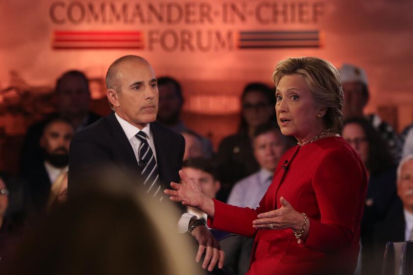 Matt Lauer looks on as democratic presidential nominee former Secretary of State Hillary Clinton speaks during the NBC News Commander-in-Chief Forum in New York City.