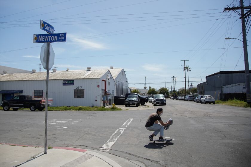 San Diego, California - April 19: A skater passes by on the corner of Sicard Street and Newton Avenue in Barrio Logan on Wednesday, April 19, 2023 in San Diego, California. (Alejandro Tamayo / The San Diego Union-Tribune)