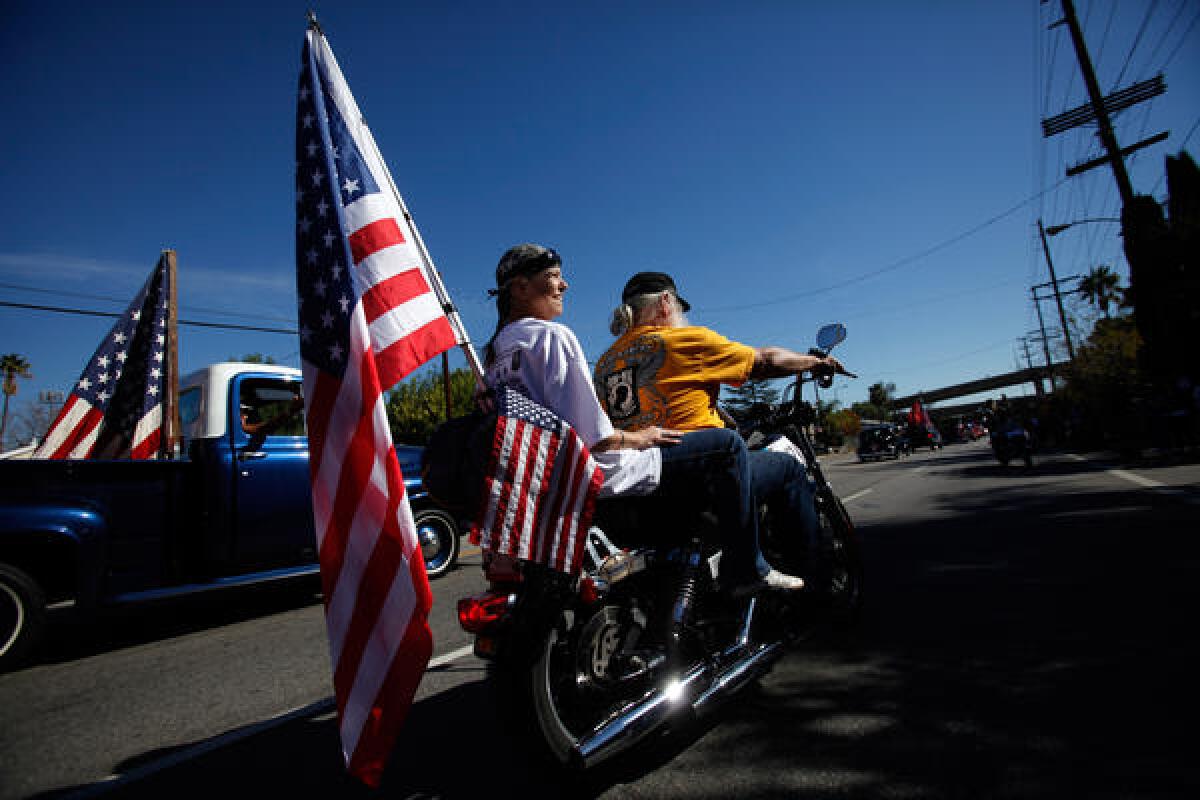 The Pow-MIA Riders, a motorcycle cub made up of veterans, drive along Laurel Canyon Blvd. during the San Fernando Valley Veterans Day Parade.