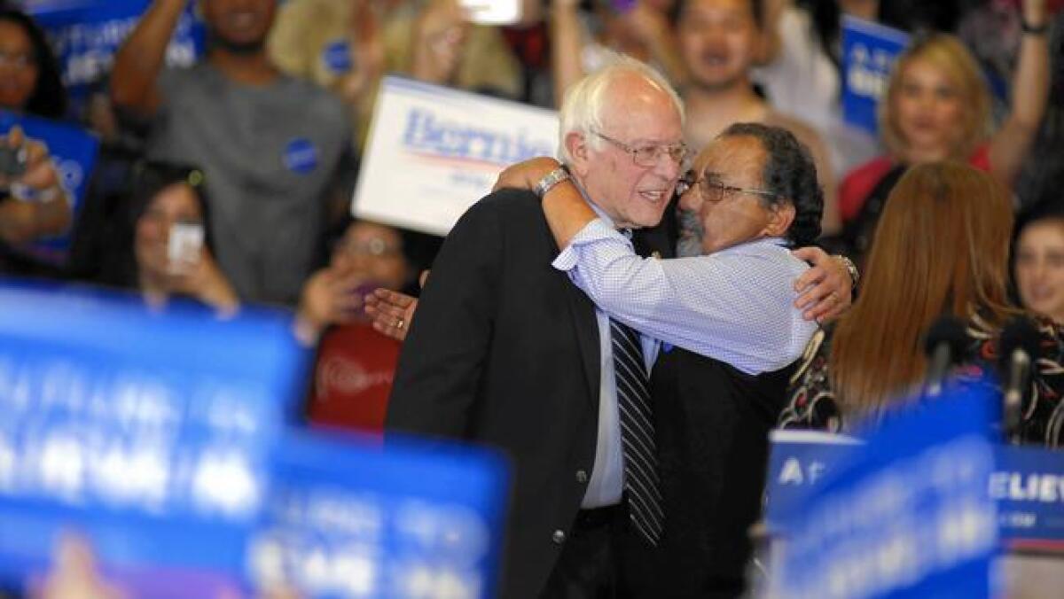 Rep. Raul M. Grijalva (D-Ariz.), right, introduces Bernie Sanders at a rally in Las Vegas on Feb. 14.