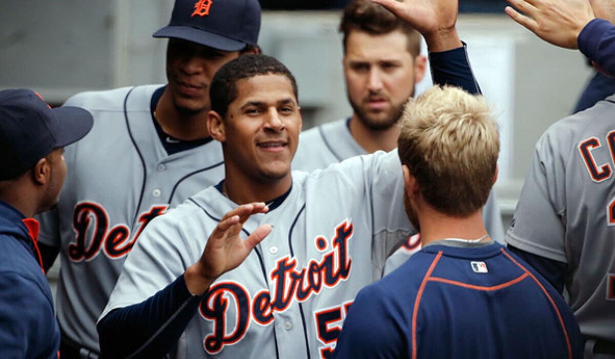 Detroit's Jefry Marte is congratulated after scoring against the Chicago White Sox on Oct. 4.