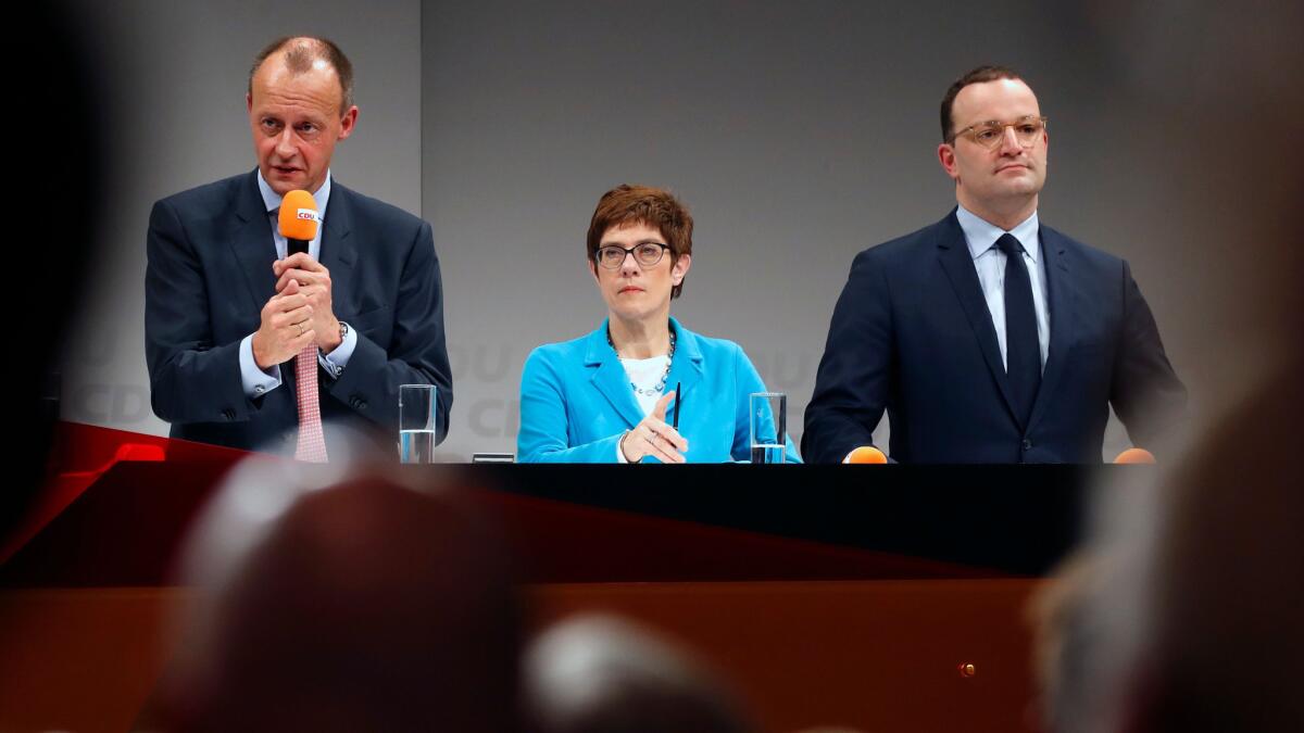 German candidates for the Christian Democratic Union party leadership Friedrich Merz, from left, CDU Secretary-General Annegret Kramp-Karrenbauer and Health Minister Jens Spahn take part in a debate in Berlin on Nov. 30, 2018.