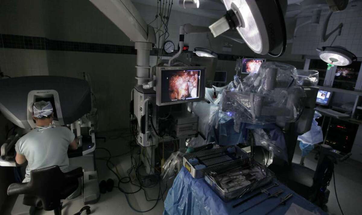 A long-term study of men with prostate cancer confirms the benefits of surgical treatment over close monitoring by doctors. Here, surgeons at University of Chicago Medical Center use a robotic system to remove a patient's prostate.