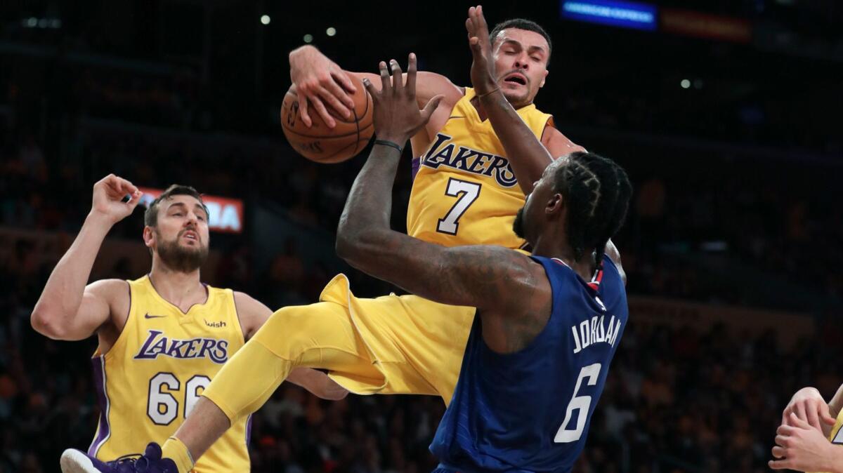 Lakers forward Larry Nance Jr. pulls down the ball after blocking a shot by Clippers center DeAndre Jordan on Oct. 19.