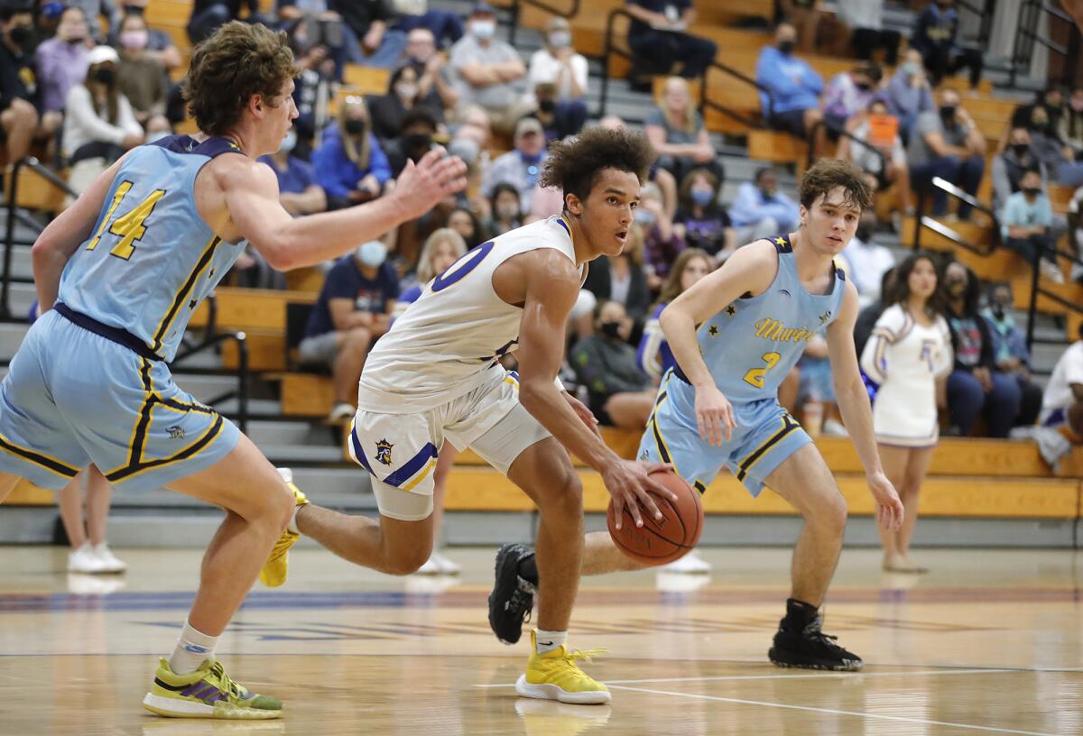 Junior point guard Roddie Anderson, center, is a key player for the Fountain Valley High School boys' basketball team.