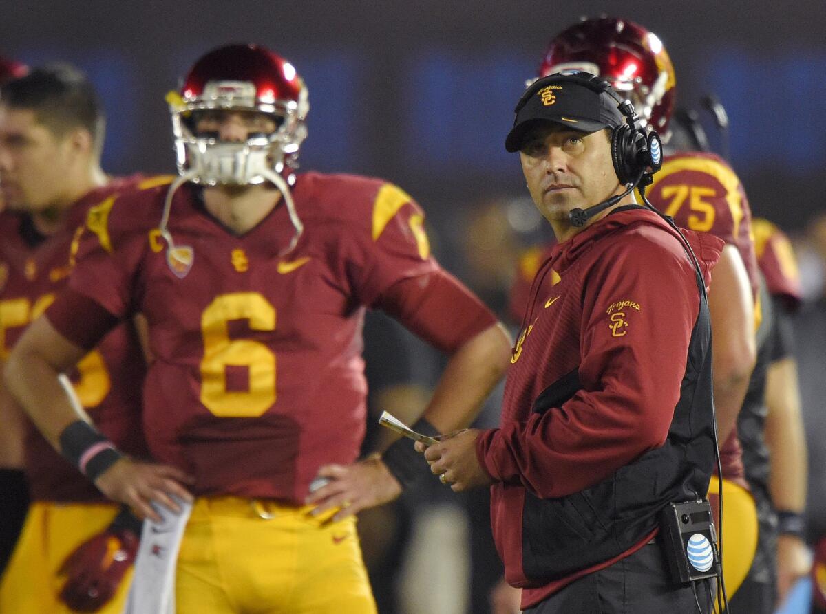 USC Coach Steve Sarkisian stands near Trojans quarterback Cody Kessler during the first half of their team's loss to the Bruins on Nov. 22, 38-20, at the Rose Bowl.