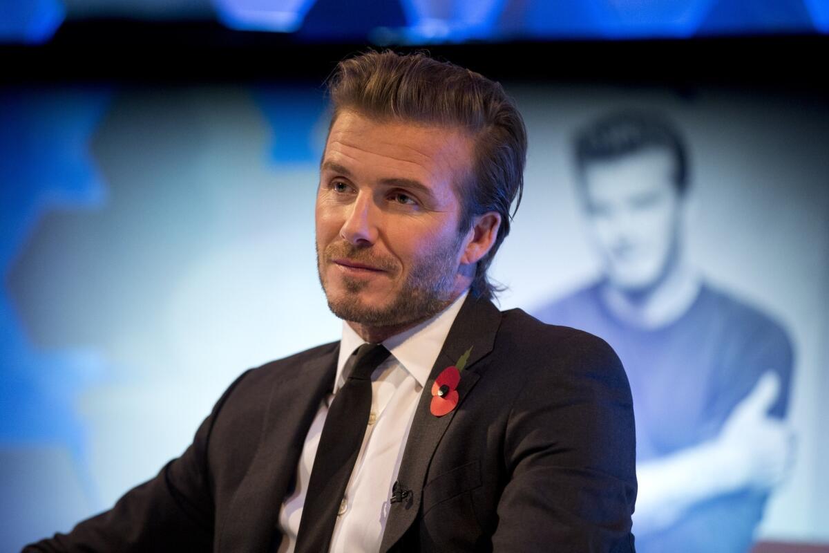 Former Galaxy star David Beckham, shown promoting his new photography book Wednesday in London, hopes to start an MLS expansion team in Miami.