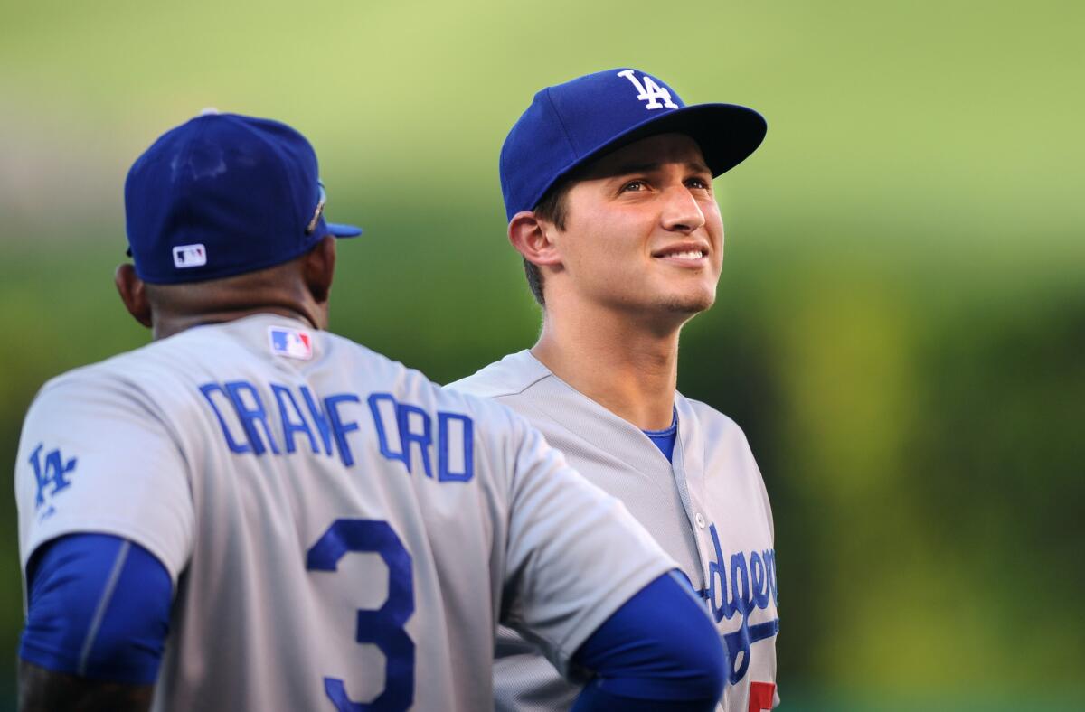 Dodgers shortstop Corey Seager chats with teamate Carl Crawford before a game against the Angels.