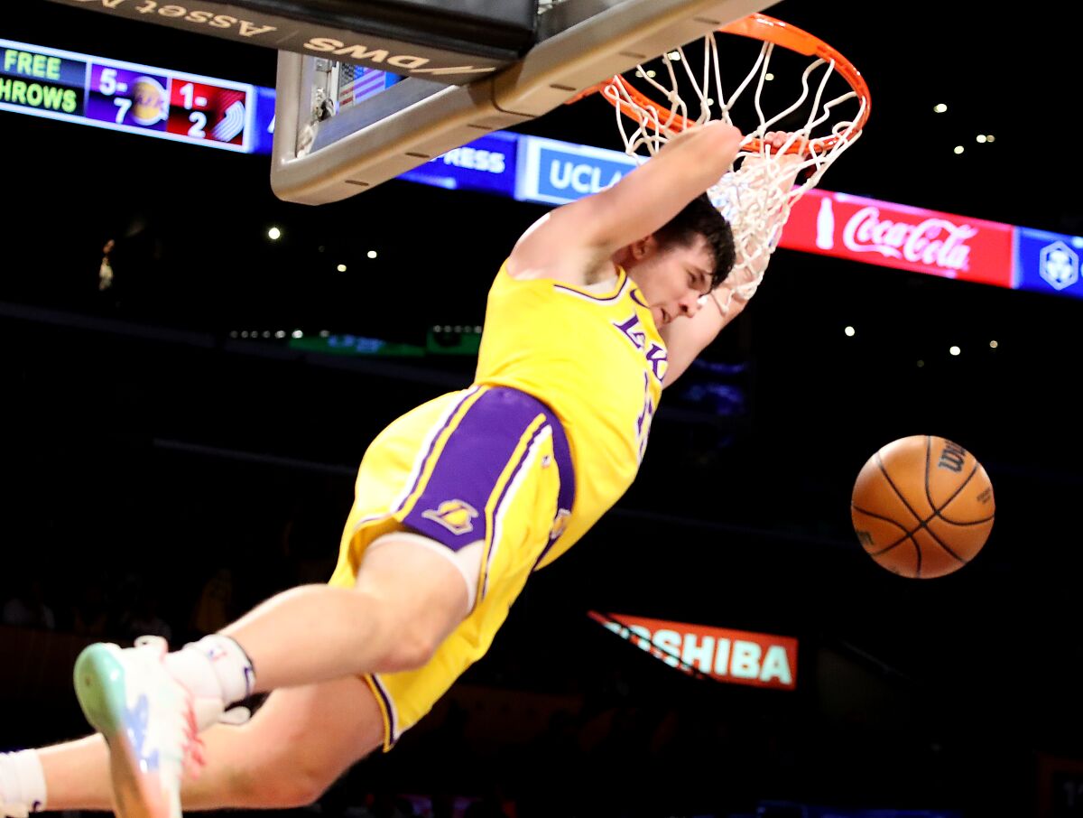 Lakers guard Austin Reaves throws a dunk against the Portland Trail Blazers.