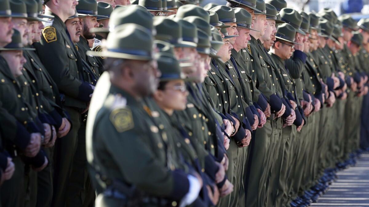 U.S. Border Patrol agents line Nashville Street outside Our Lady of Guadalupe Church in El Paso for the funeral Mass of fellow Agent Rogelio Martinez.